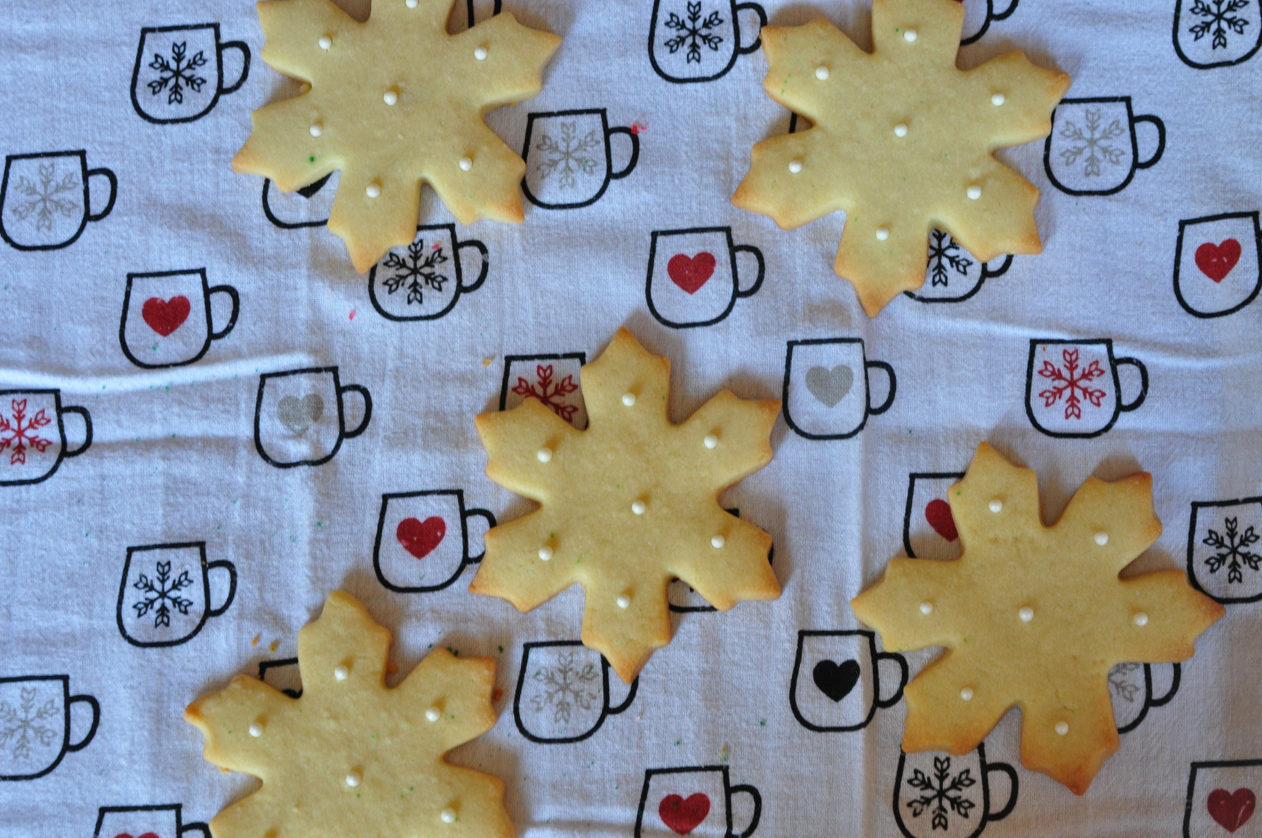 butter sugar cookies recipe image snowflake shaped cookies with pearl colored nonpareils